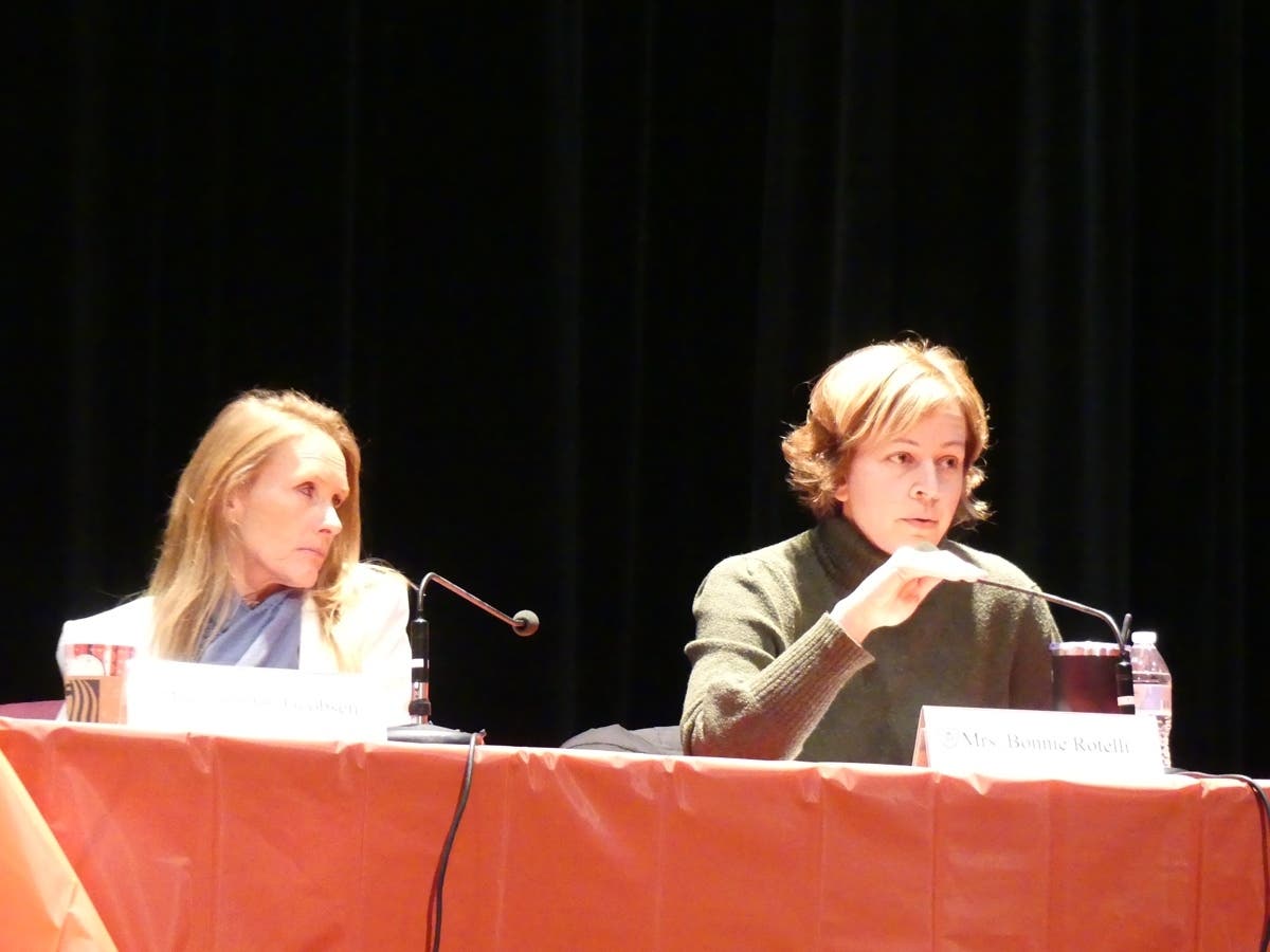 School board member Bonnie Rotelli (right) speaks Wednesday at a town hall event.