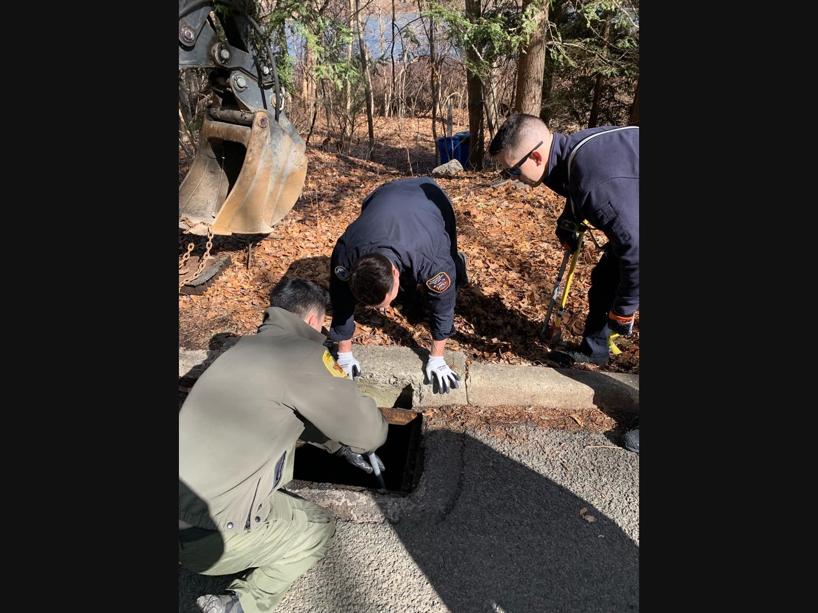 Fairfield emergency personnel work to rescue a dog Friday from a sewer drain.