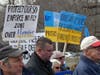 Attendees hold up signs at a rally Saturday to support Ukraine.