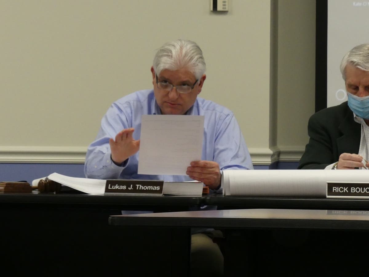 Chair Luke Thomas reads letters aloud during a recent Inland Wetlands Agency meeting.