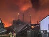 Firefighters battle the blaze at Forsman Farms.