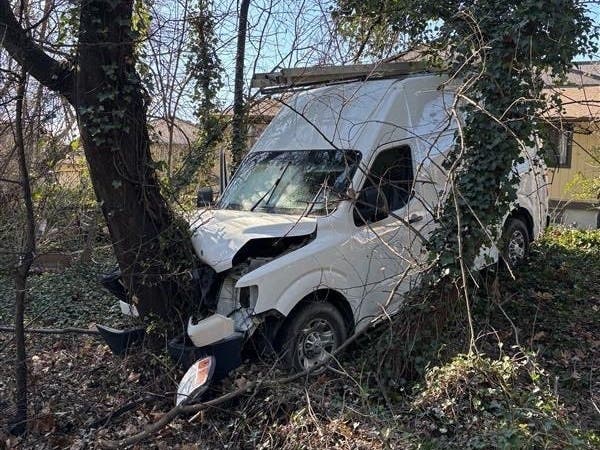 The officers fired their weapons and hit the driver, who crashed the van, injuring the passenger, according to the department.