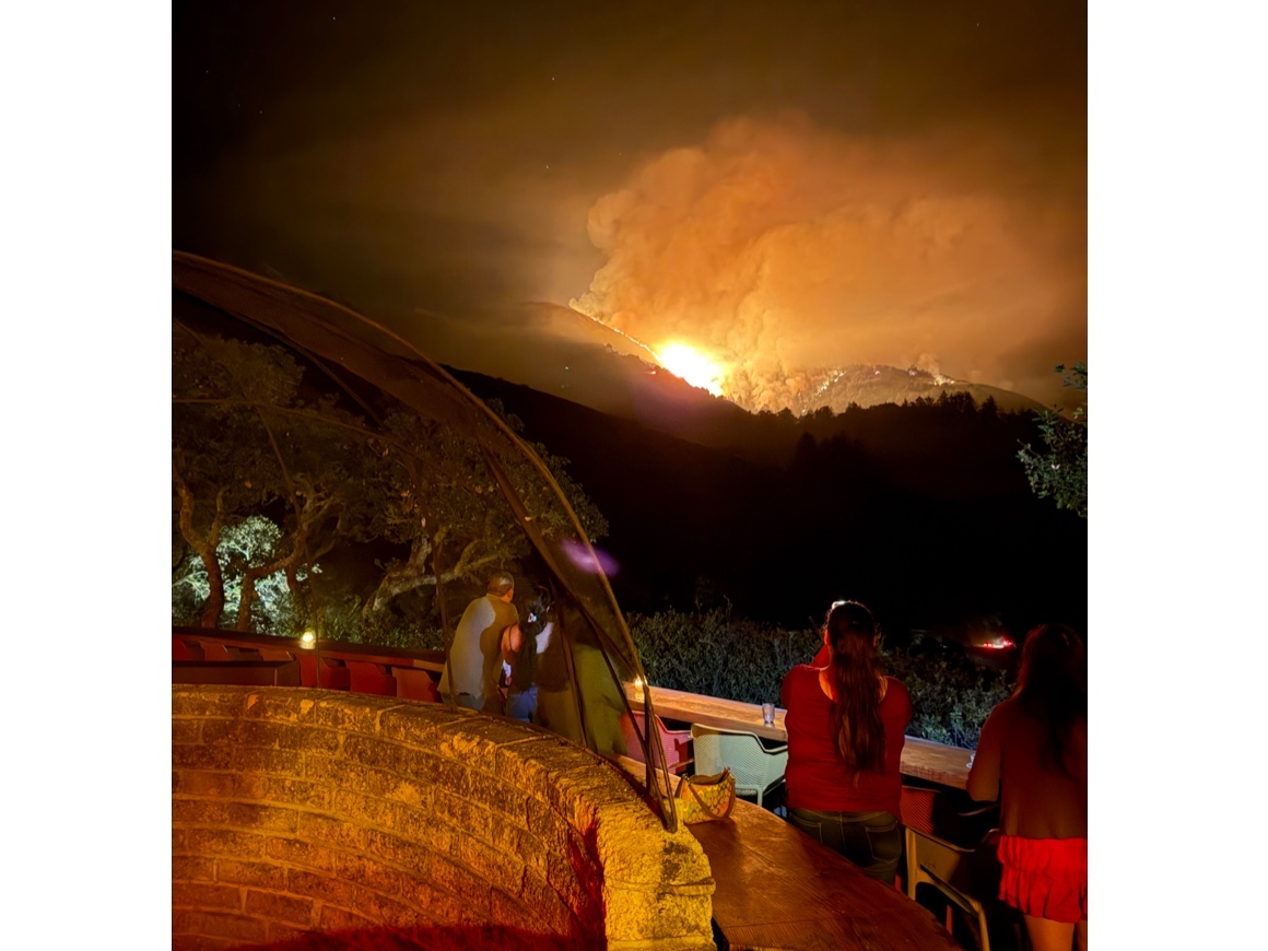 People look on as the Timber Fire burns near the Nepenthe property.