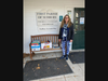 Rhona at Sudbury Extended Day poses with books donated by the Friends of the Goodnow Library