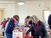 Community volunteers fill Roundtable Valentine's Day gift bags for residents of area domestic violence shelters and transitional housing