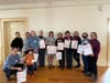 Roundtable members and community volunteers pose with Valentine's Day gift bags. Fifty five bags were delivered to families affected by domestic violence. 
