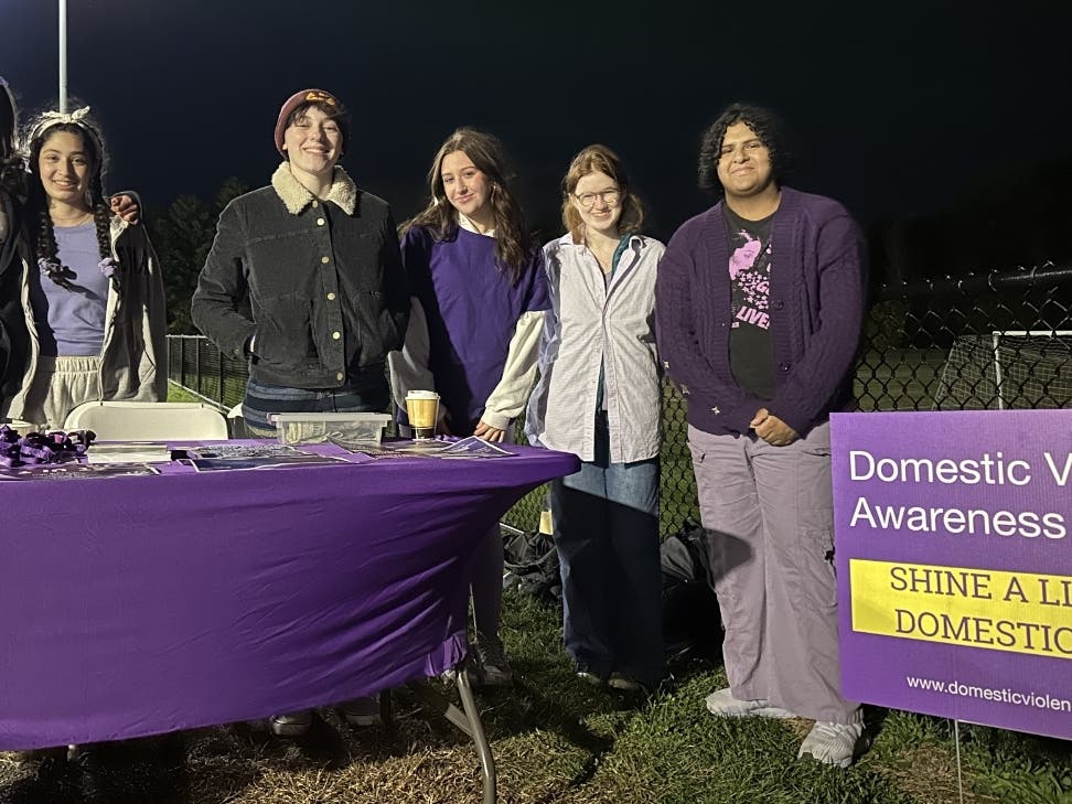Students from STEW and the Mentors in Violence Prevention Program at 2024 LS Wayland Football Game working to shine a light on relationship violence