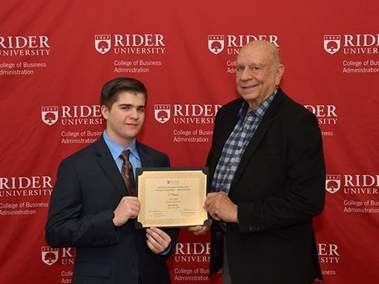 From left: Eric Voros, now a freshman at Rider, and entrepreneur Norm Brodsky '64 pose after Voros won a full, four-year scholarship to the university through the 2019 Norm Brodsky Business Concept Competition.