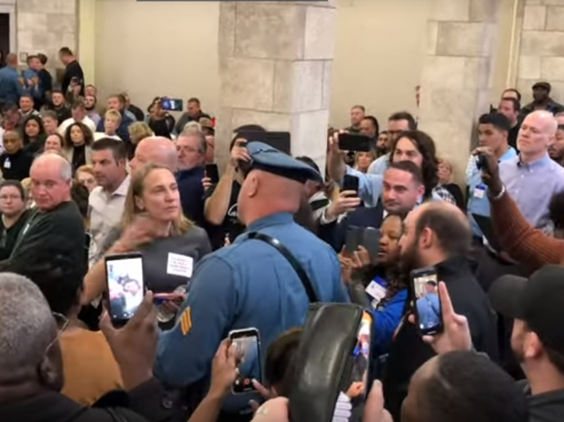 Sue Altman, moments before State Troopers dragged her from a hearing on the EDA Tax Incentive Program.