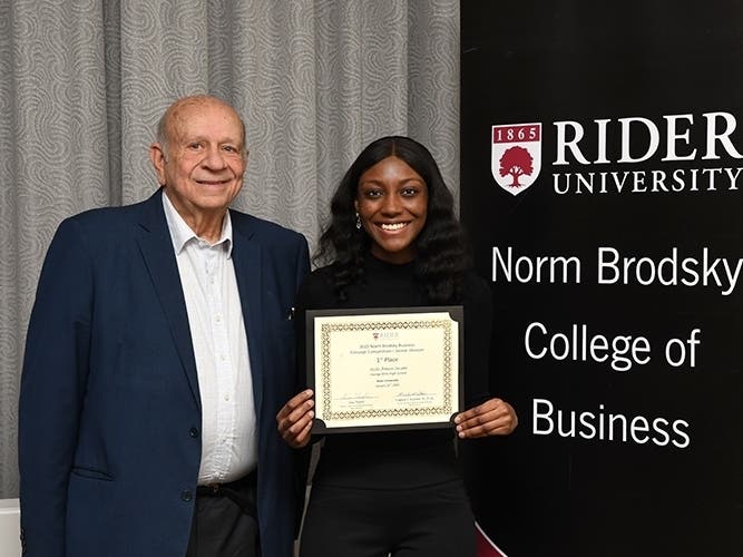 From left: Entrepreneur Norm Brodksy poses with Jayla Armani Swann, the winner of the 2020 Norm Brodksy Business Concept Competition.