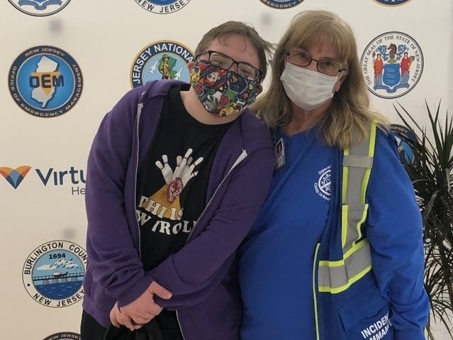 Phyllis Worrell, emergency preparedness coordinator for Virtua Health, poses with Noah McGrath after he received his vaccination in the sensory room at the Burlington County Mega-Site.