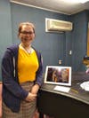 Olivia Isabella West-Signore stands with her photograph "Through A Lens"