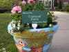 Allie Falconer's Painted Flower Pot, sponsored by Courtyard Florist, sits at the entry to Town Hall
