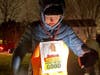Cathy Ricketson, chairperson for the Westford Democratic Committee & event supporter, stands out in the cold to hold candles for Justice for Renee Nicole Good