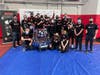 The team poses with the robot following the end of a successful day at the North Shore competition.