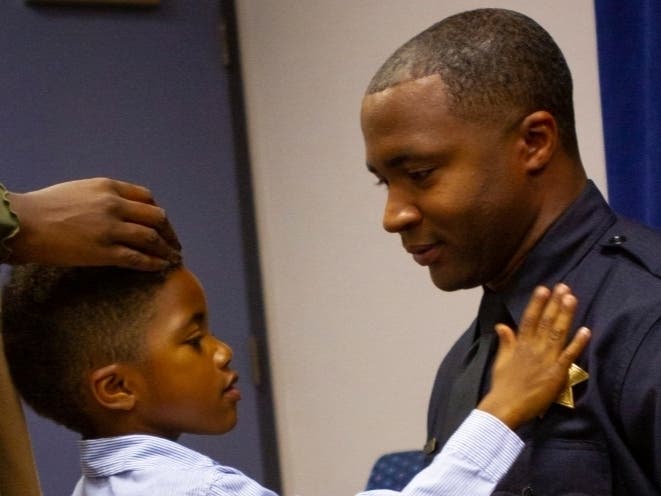 Taft Bradley being pinned by his young son during the June 19 swearing in.
