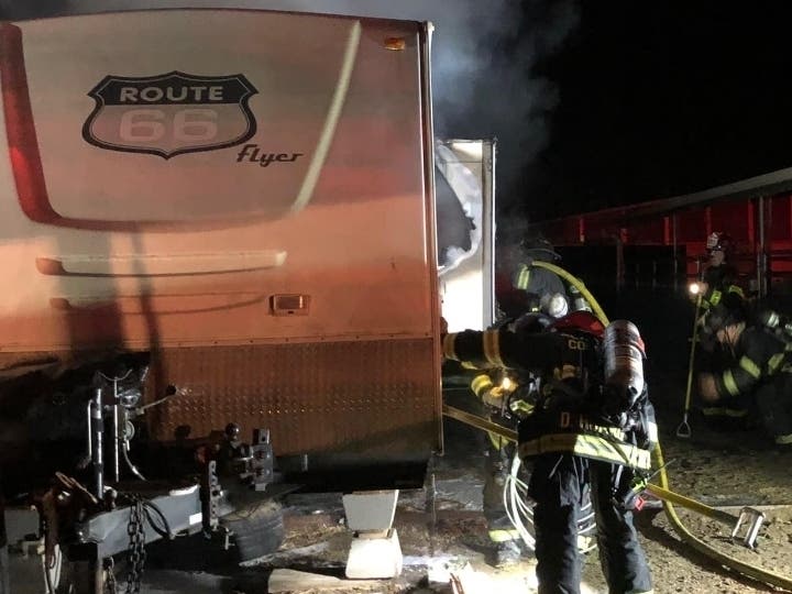 Crews work to douse the trailer fire at the facility.