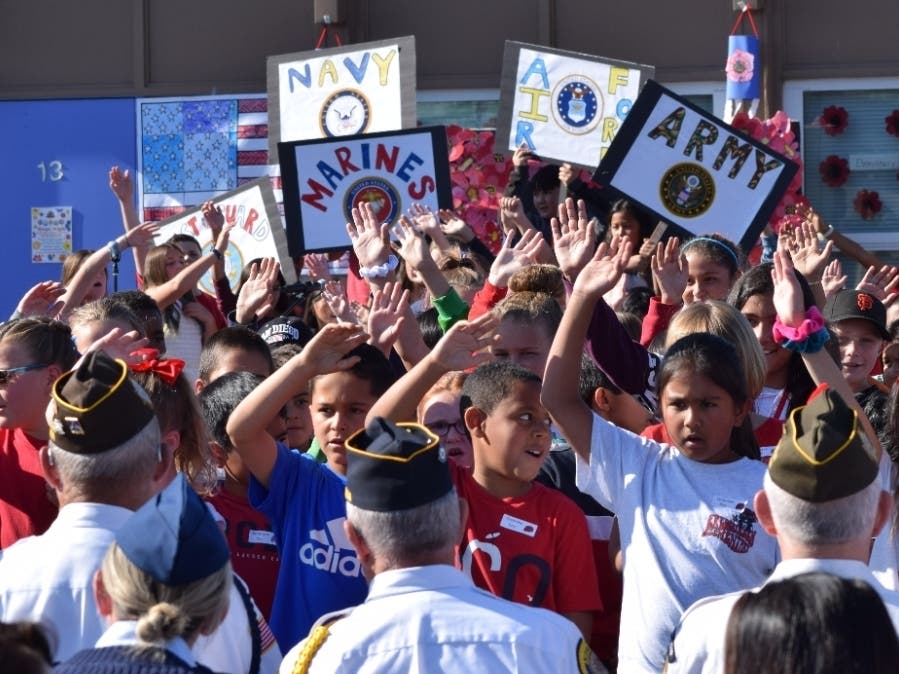 Frederiksen Elementary School students along with veterans and active-duty service personnel join on campus to commemorate Veterans Day.