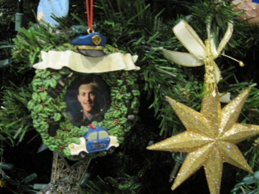 A tree ornament with Deputy John Monego's photo.