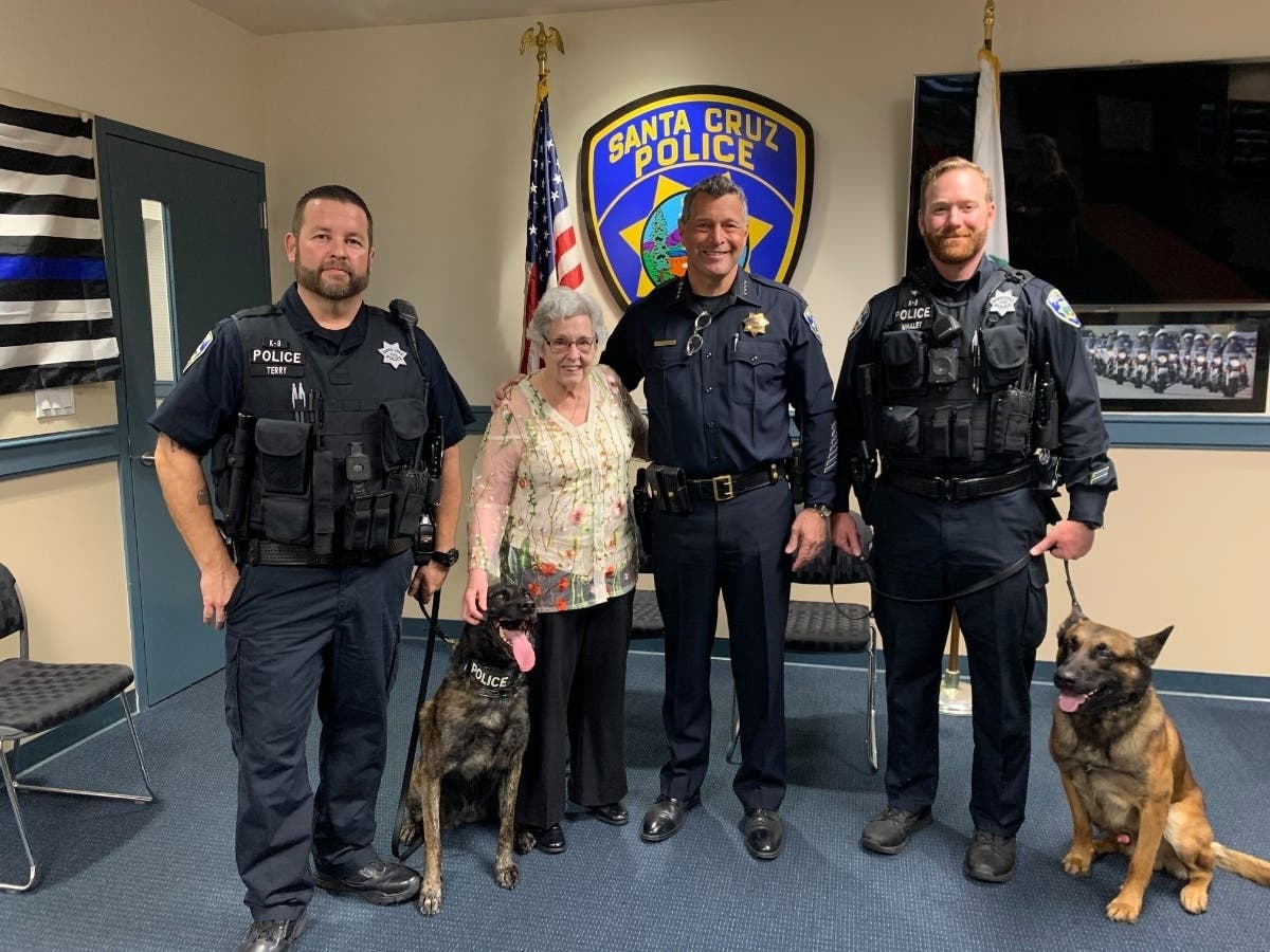 From left: Officer Terry and Luna, Joanne Parker, Chief Andrew Mills, and Officer Whaley with Ryder.