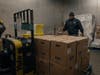 Pechanga warehouse team member Darren Henderson stacks melons and pineapples high on a pallet jack