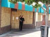 Onlookers peek outside a boarded up business in Lake Elsinore. June 3, 2020.