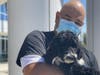 An emergency department team member at Loma Linda University Medical Center in Murrieta holds Benjamin, a Standard Poodle puppy that is a service dog in training.