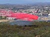 An air tanker drops fire retardant on the blaze.