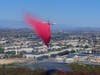 An air tanker makes a water drop on the fire.