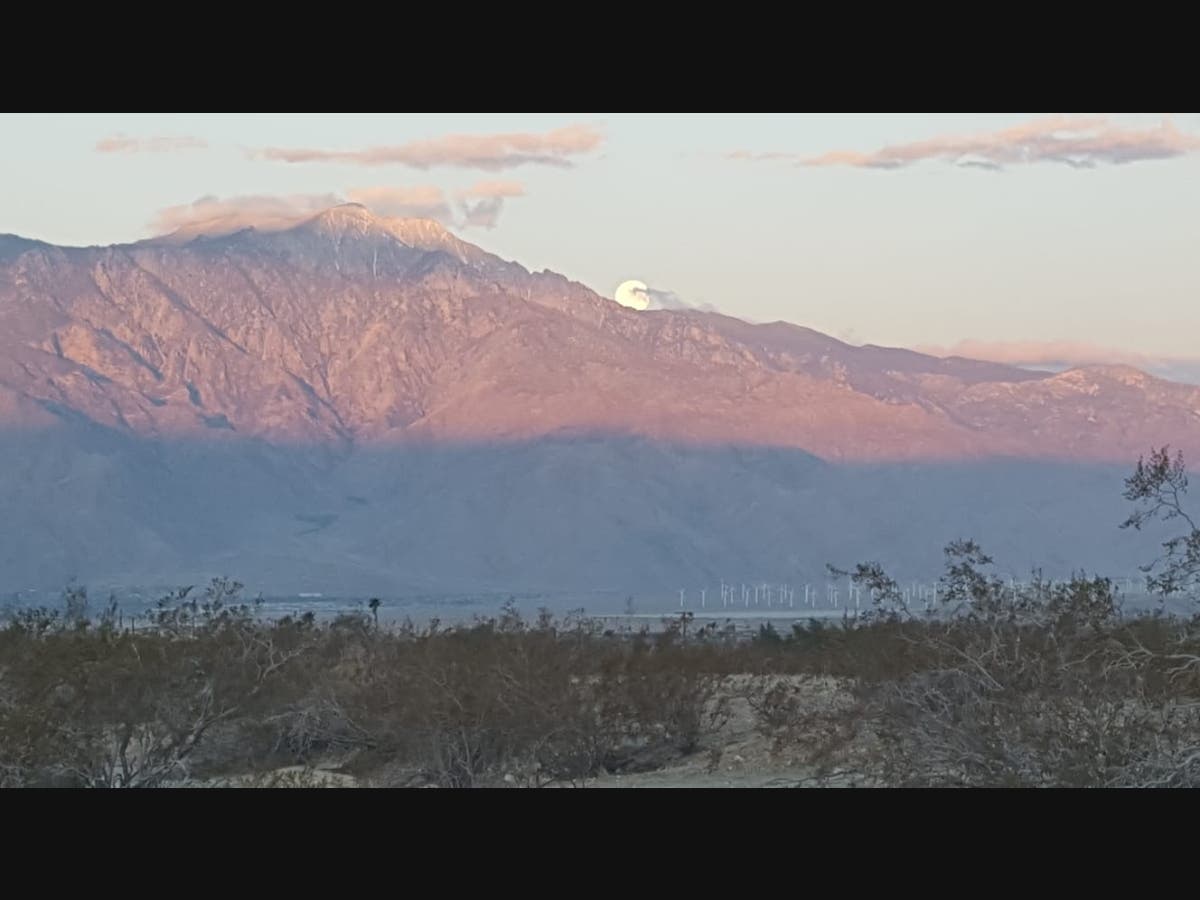 A view from Sky Valley shows the 2021 Pink Supermoon setting on April 27.