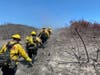 Crews work Tuesday in the Chaparral Fire burn area.
