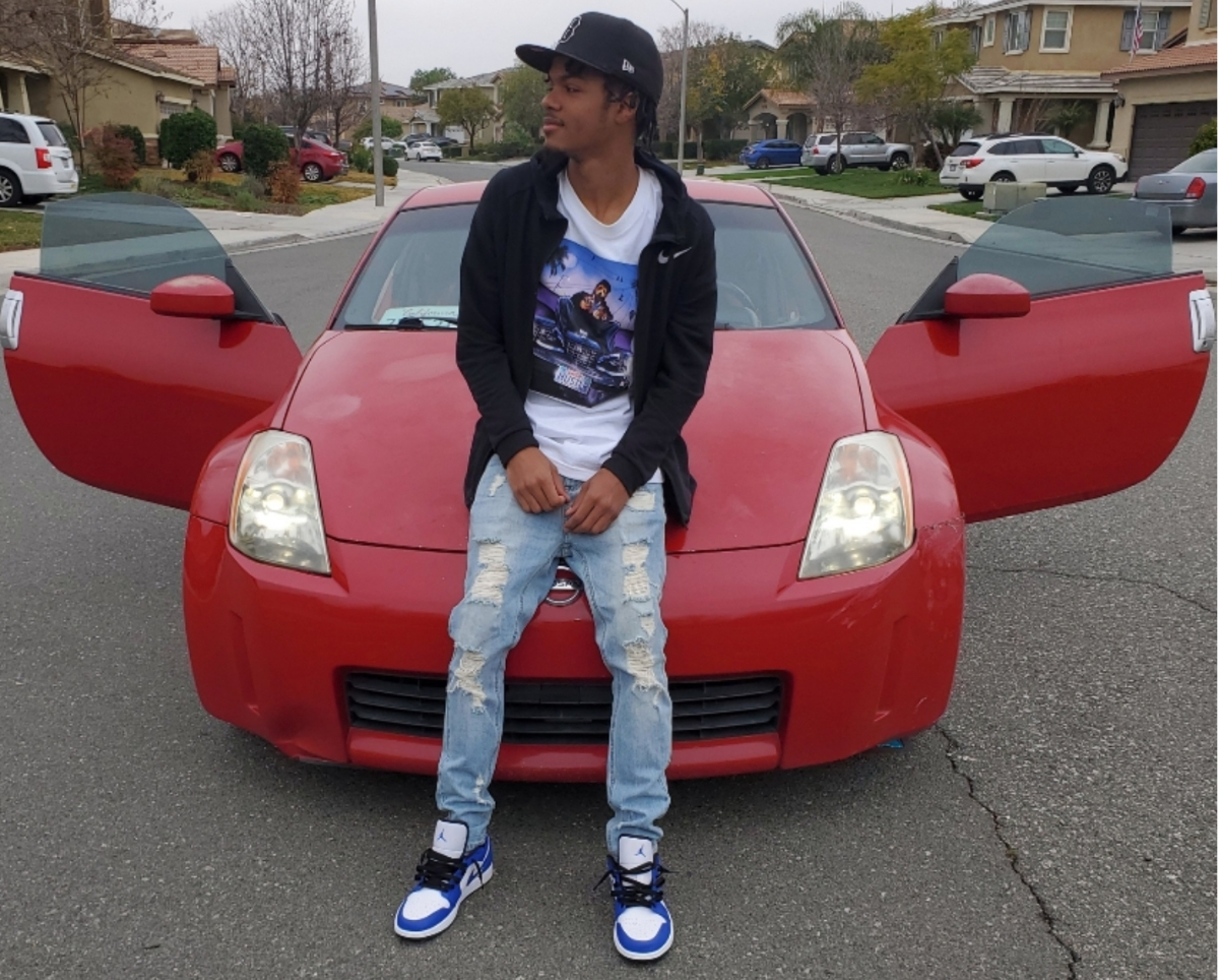 Ajanni "AJ" Cabrera and his 2004 Nissan 350Z in front of the family's Menifee home. The photo was taken by his mom after he purchased the car with his own money that he worked overtime to save, she said.