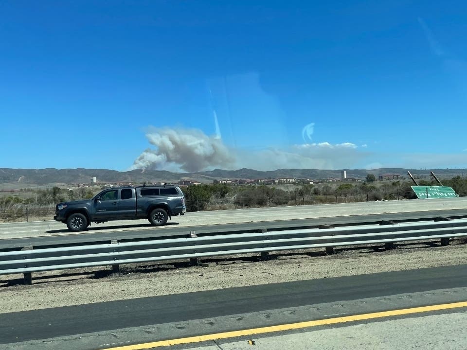 The brush fire smoke plume viewed from Interstate 5, near the Orange County-San Diego County line.