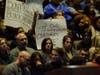 Community members hold signs opposing newly elected Temecula Valley Unified School District board members during the Dec. 13, 2022, board meeting at the Temecula Valley High School Theater.