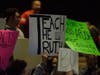 Community members hold signs opposing newly elected Temecula Valley Unified School District board members during the Dec. 13, 2022, board meeting at the Temecula Valley High School Theater.