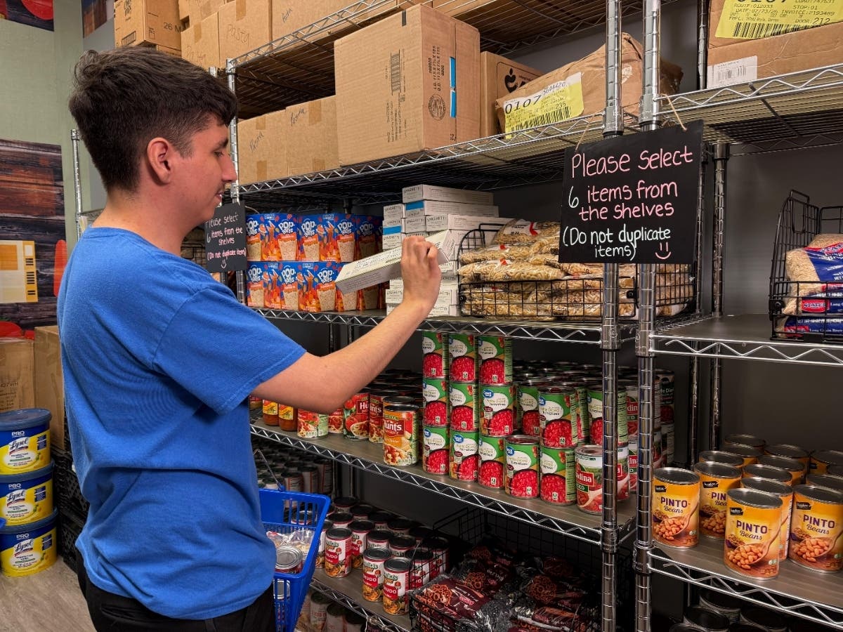 Sebastian Bautista, CSUSB first-year student, reviews ingredients on an item at the CSUSB Palm Desert Campus DEN Food Pantry.