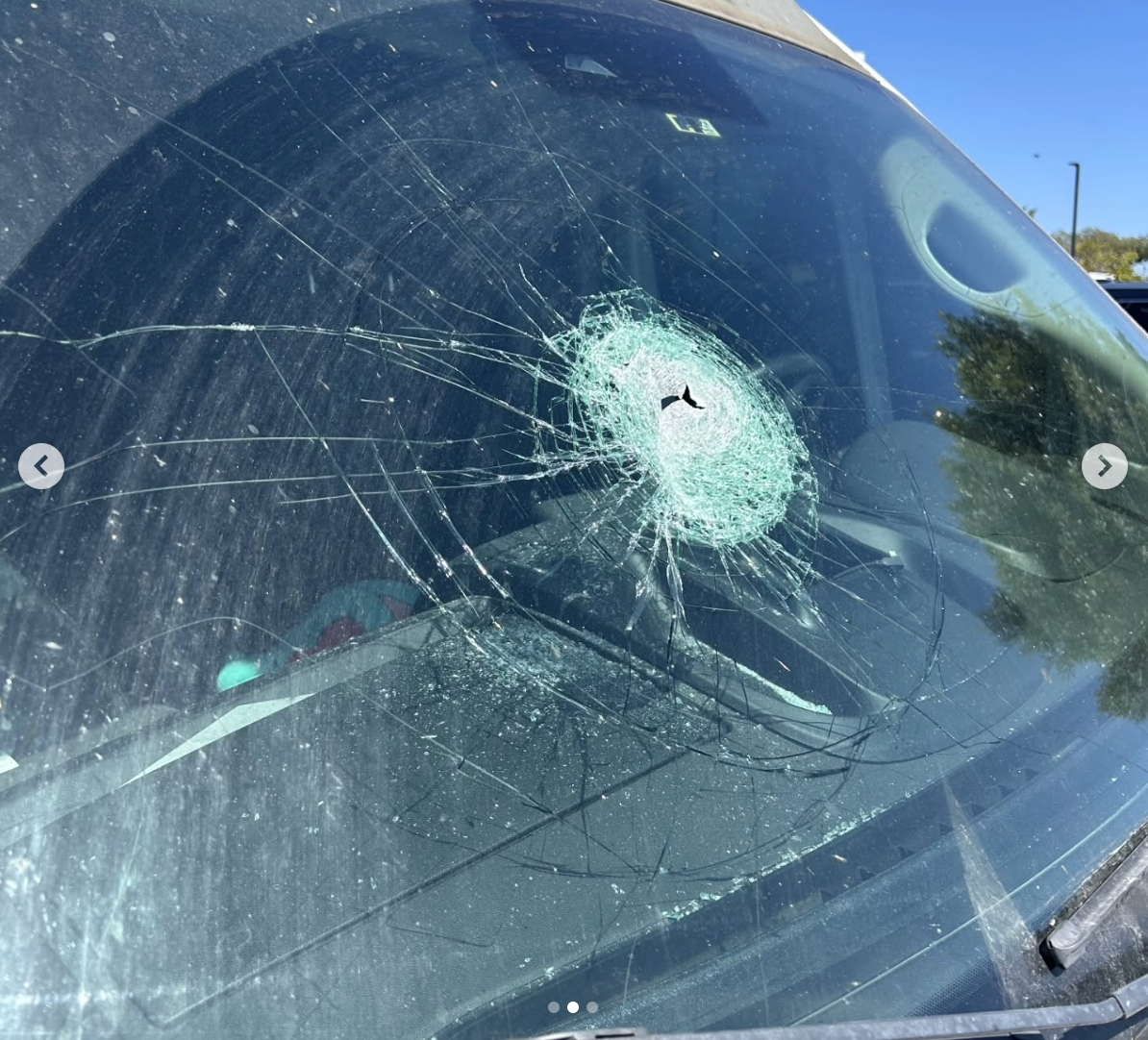 The damage to the woman's van that was caused by the flying debris.