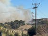 A helicopter drops water on the Volcano Fire as seen from the Santa Rosa West community on the plateau.
