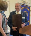 Rotary president Gail Linenberg congratulates Max Rose, the club's Rotarian of the Year. 