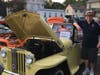 Bill Cope of Doylestown stands next to Bruce Rutherford's yellow 1948 Willys Overland Jeepster.